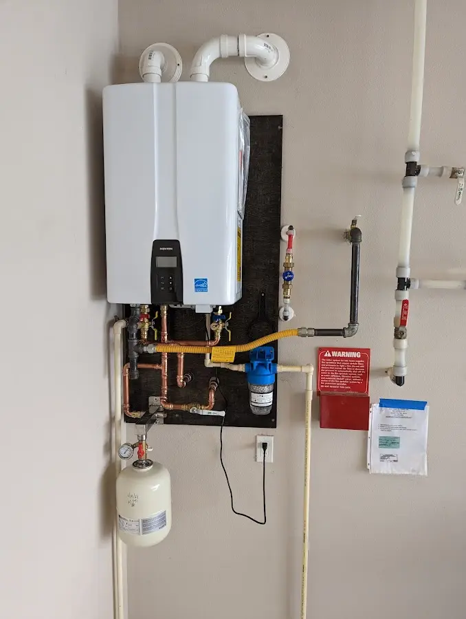 Professional plumber installing copper piping in a South Valley home